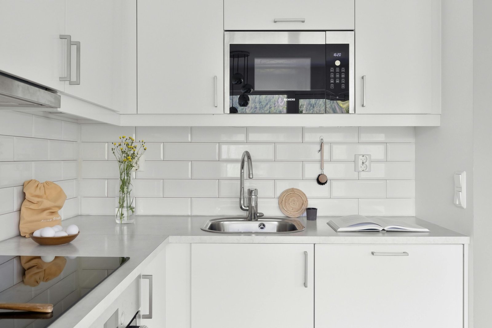 Modern glass tile backsplash with stainless range hood