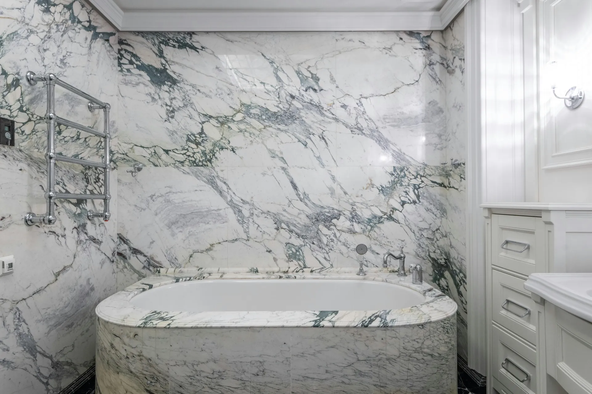 Built-in tub and feature wall finished in dramatic marble-look Caesarstone