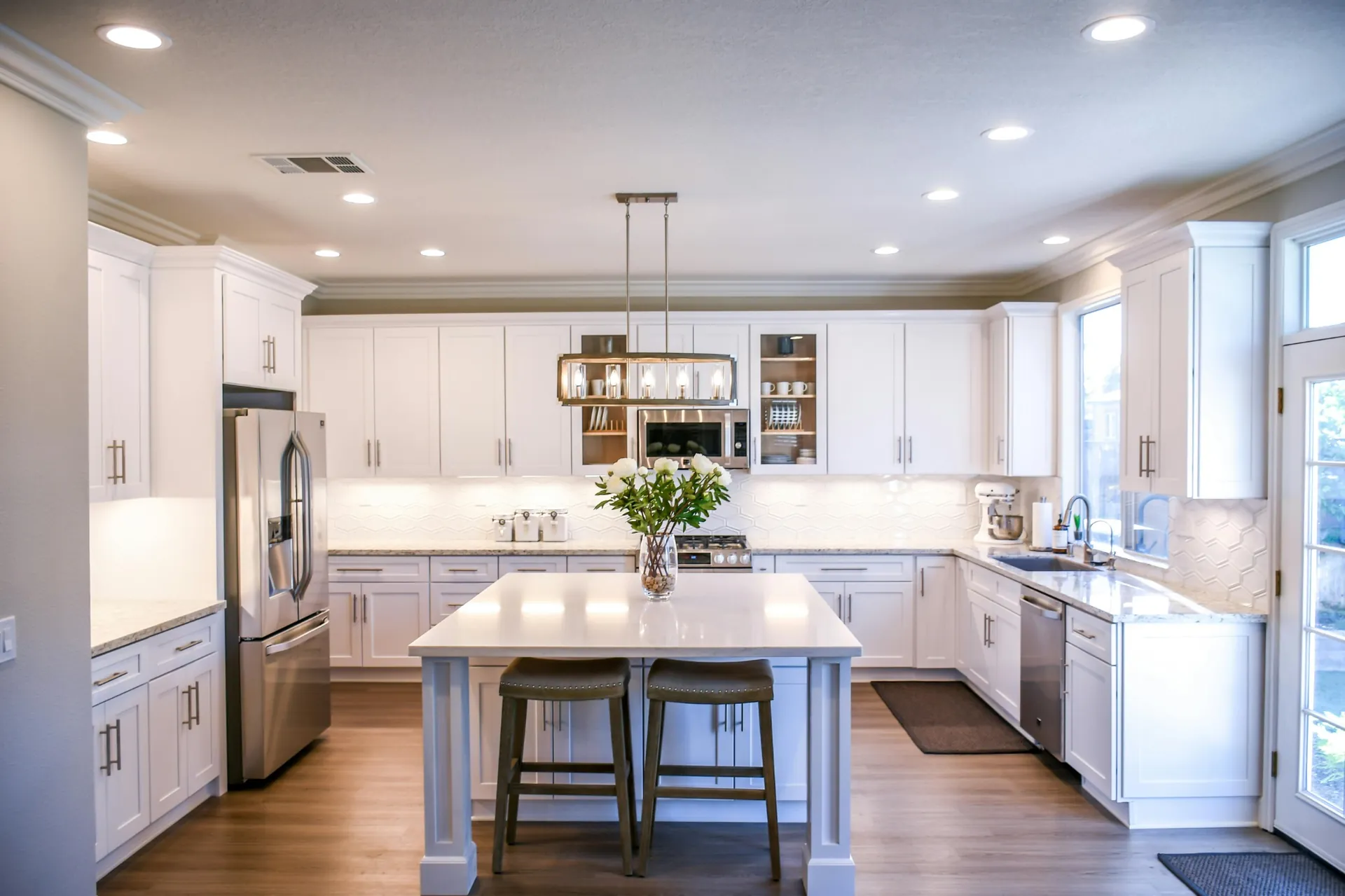 Bright white kitchen with quartz island and perimeter countertops